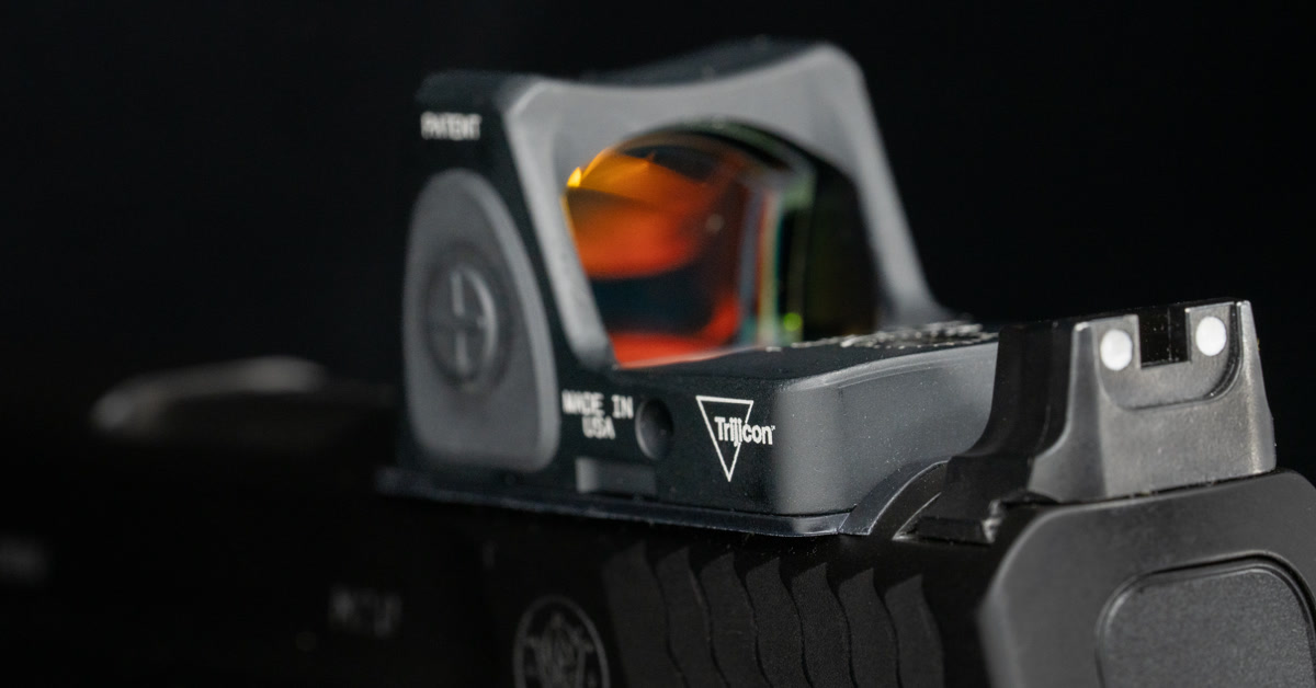 Close-up of a Trijicon RMR red-dot optic mounted on a Smith & Wesson M&P 2.0 pistol slide.